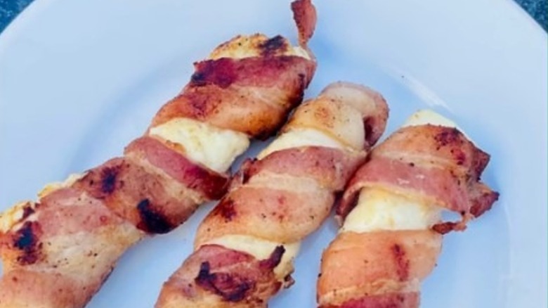 Bacon wrapped around cheese