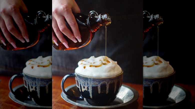 Maple syrup poured onto hot chocolate and whipped cream
