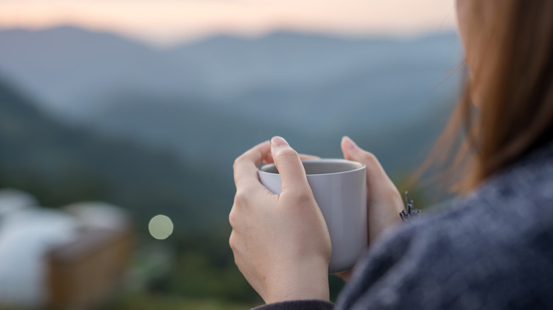 holding tea outside