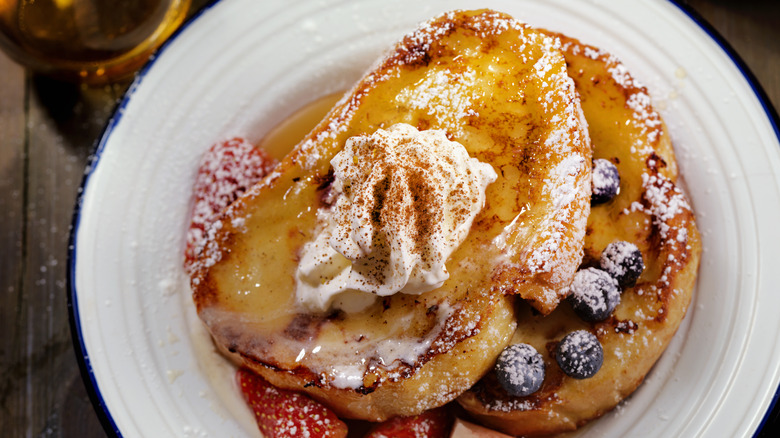 French bread with whipped cream, berries and syrup