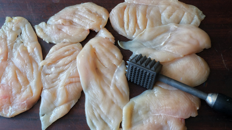 Flattened chicken breasts and mallet