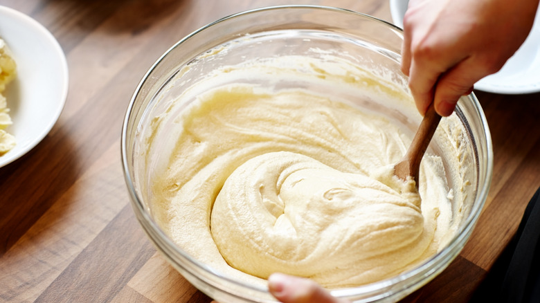 mixing batter with wooden spoon