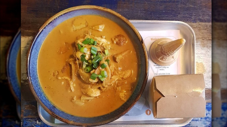 bowl of rendang curry on a tray 