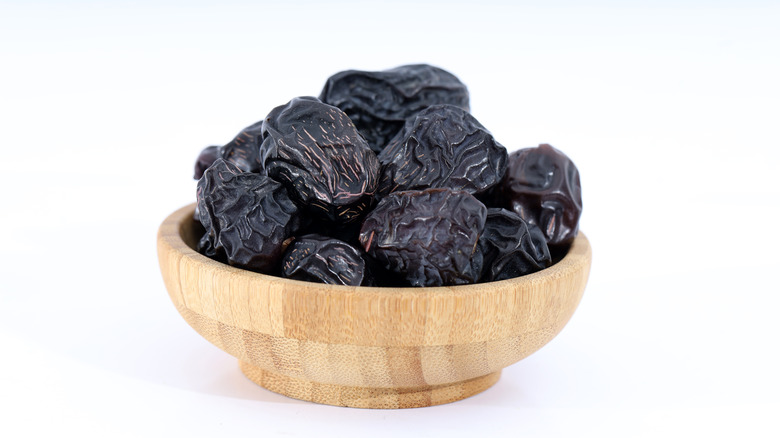 Ajwa dates in wooden bowl