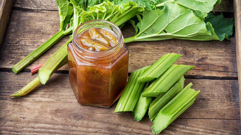 Rhubarb preserves and stalks of green rhubarb.