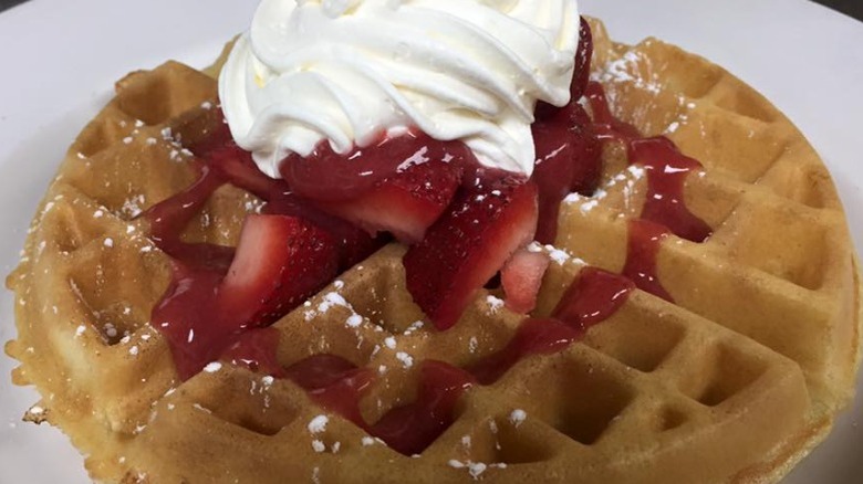 Waffle with strawberries, whipped cream