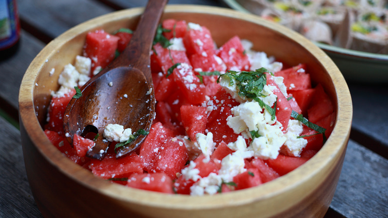 Watermelon salad in wooden bowl with feta