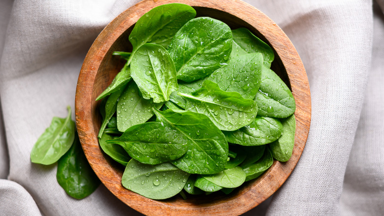 A bowl of raw spinach leaves