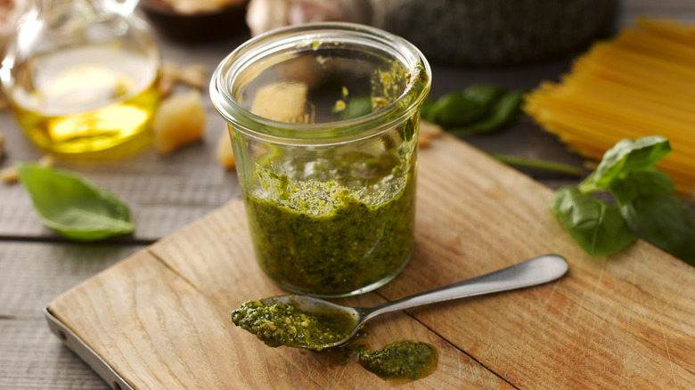 A jar of pesto and a spoon