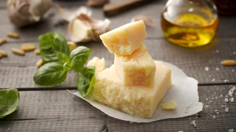 Stacked chunks of Parmesan cheese with basil