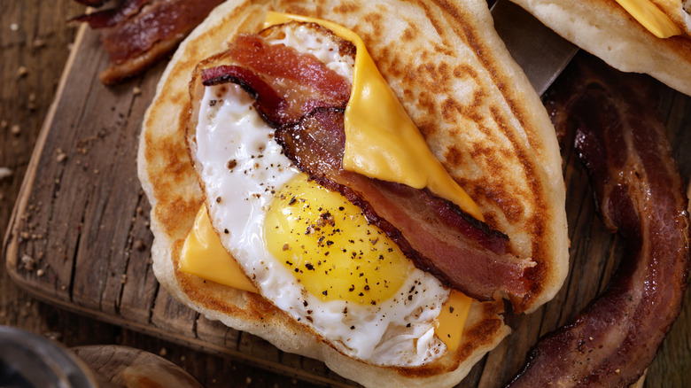 Pancake wrap with bacon, cheese, and fried egg