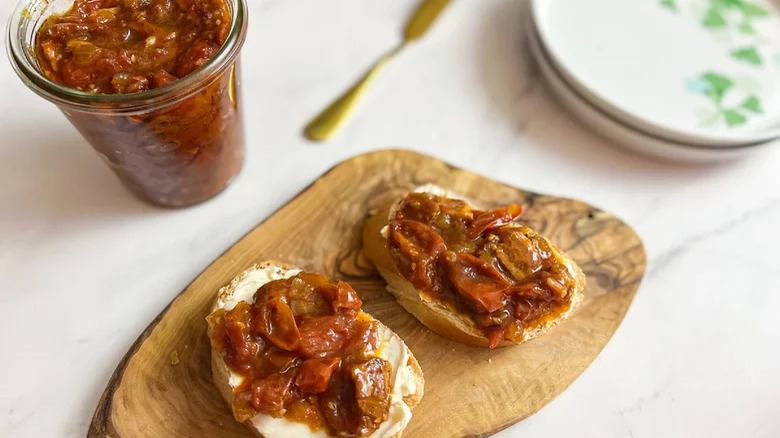 Tomato and bacon in jar and on bread slices