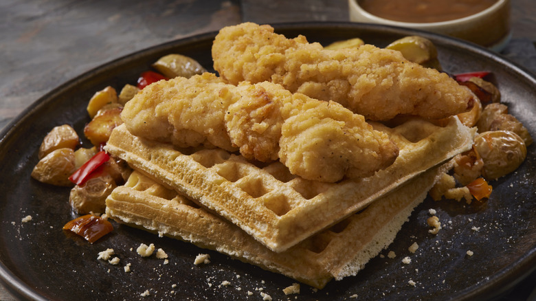 chicken and waffles on black plate