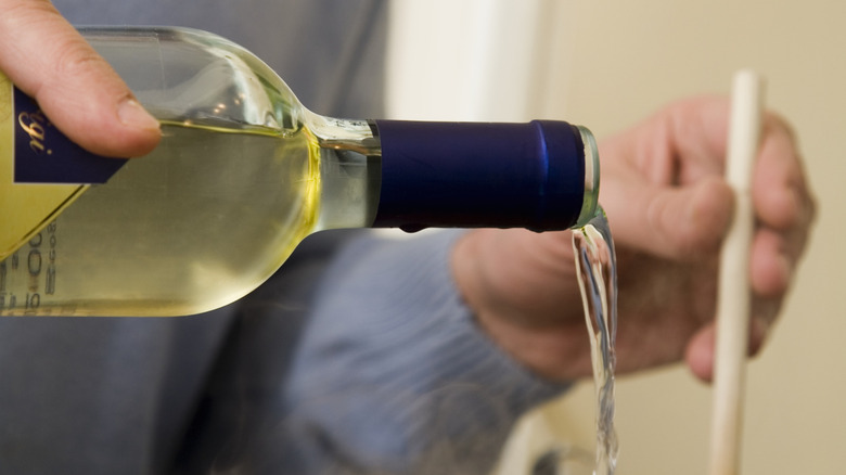 White wine being poured into a pot