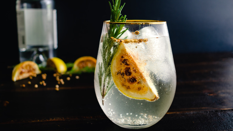 charred lemon with rosemary in gin and tonic