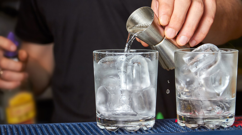 pouring a measaure of gin in glasses