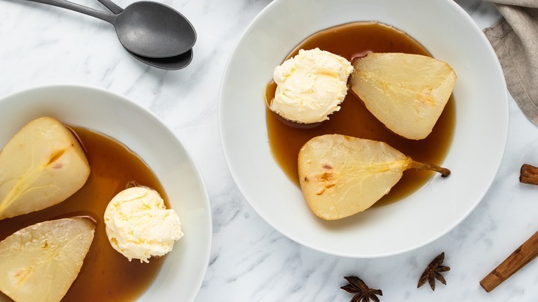 poached pear halves in bowls