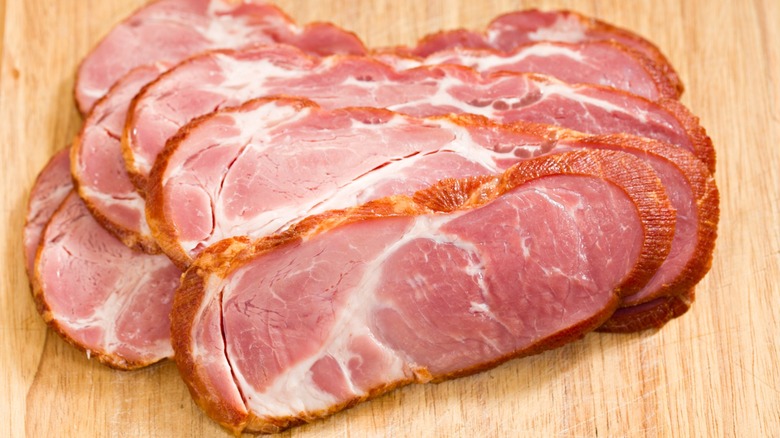 Slices of cottage bacon on wood table