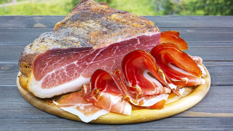 Slab of speck on wooden board