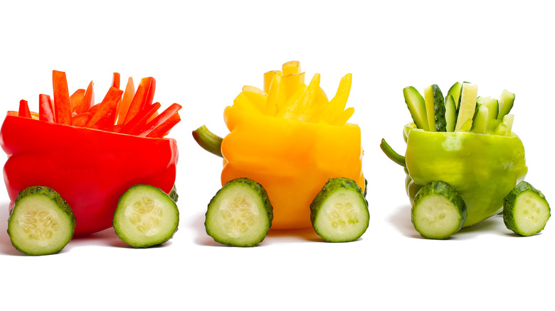 red yellow green bell pepper train cucumber