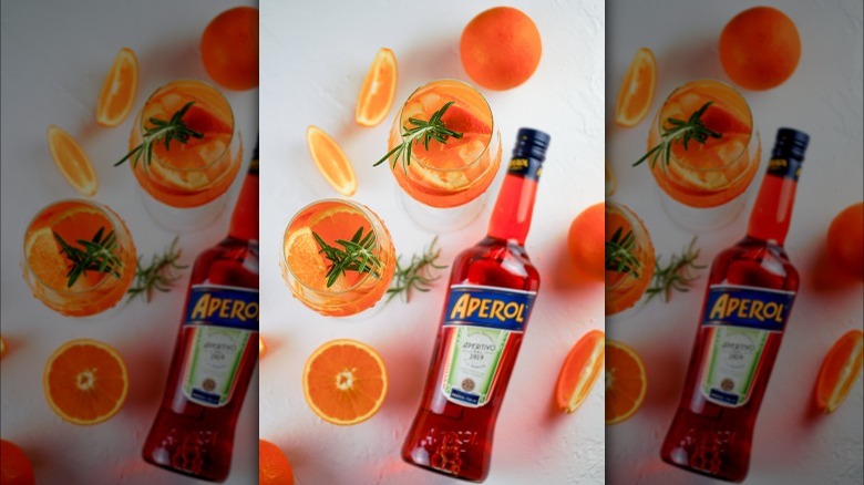 Aperol bottle with spritz drinks