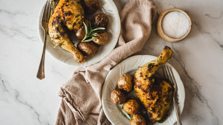 chicken and potatoes on plates