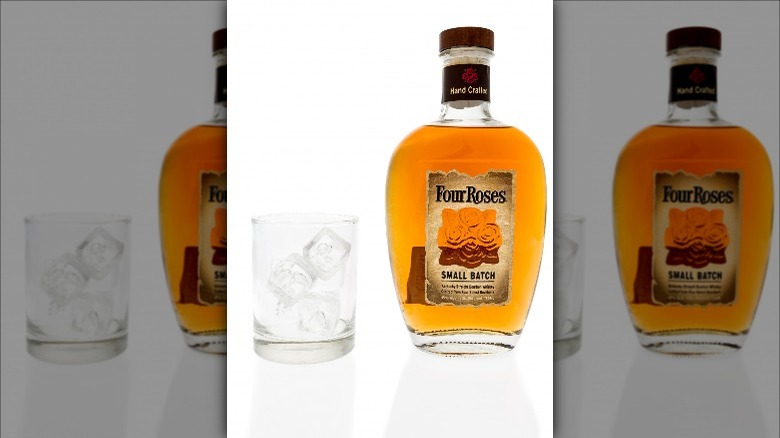 Glass and bottle of Four Roses whiskey