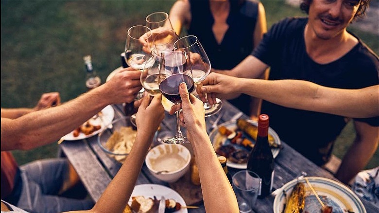 people toasting with wine glasses