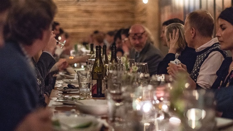 people seated at long dining table