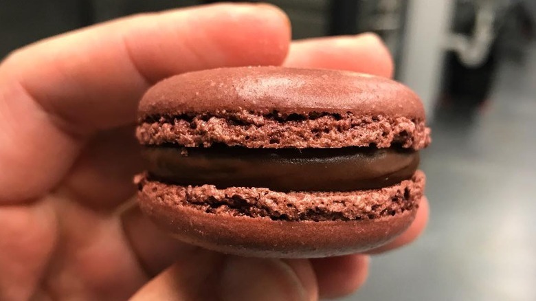 Dark chocolate macaron close up 