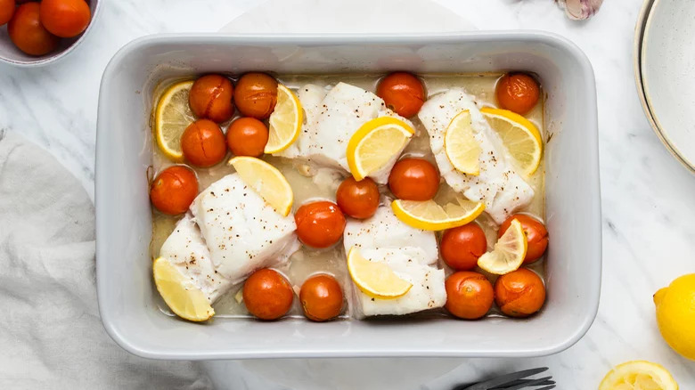 Cod fillets with lemon slices and cherry tomatoes