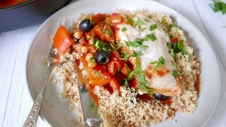 Cod fillet with tomatoes, olives, and couscous