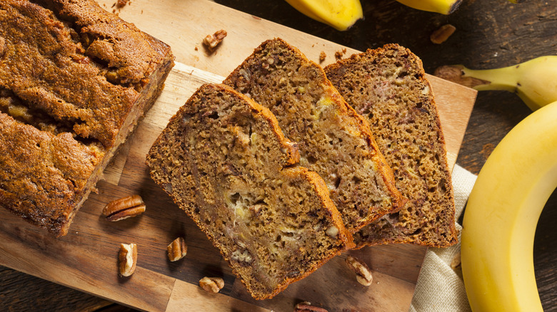 sliced banana bread with bananas and pecans