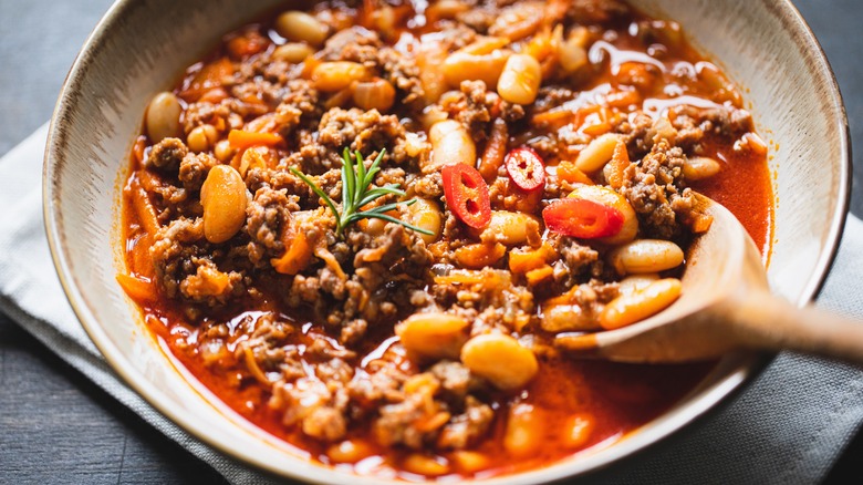 chili in bowl with a wood spoon