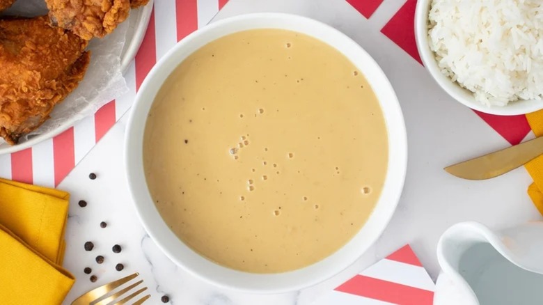 Light brown gravy in white bowl