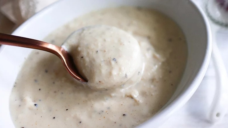 Spoon dipping into creamy gravy