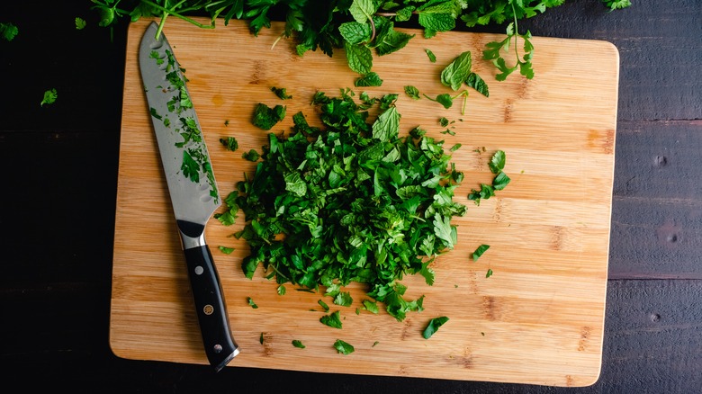 fresh chopped herbs on cutting board