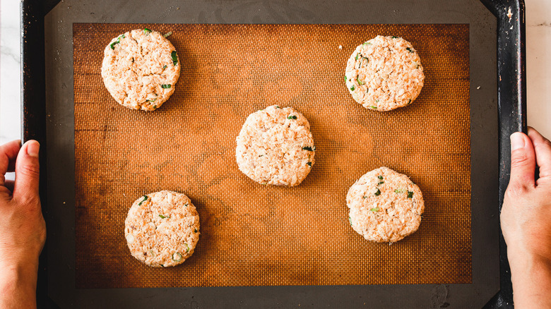 salmon cakes on baking sheet