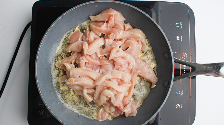 Sliced chicken in pan