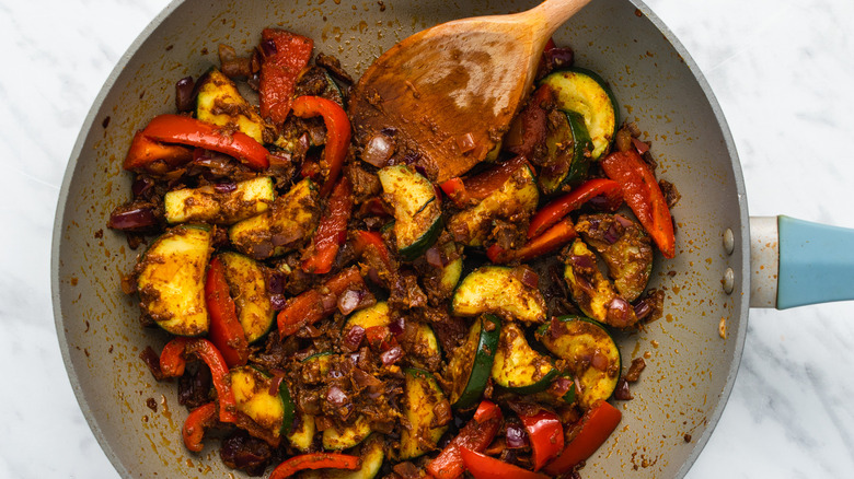 Garlic curry ginger cooking in metal pan