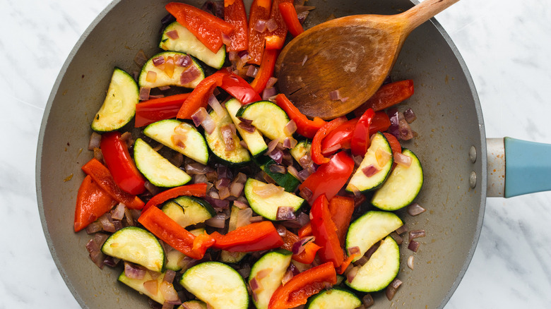 Frying vegetables in metal pan