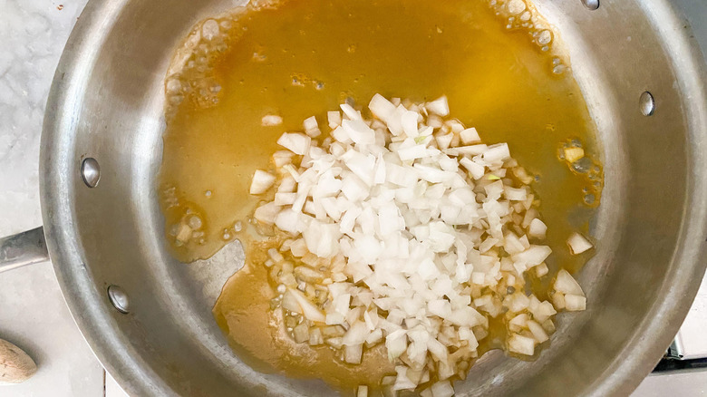 diced onions, broth in skillet 