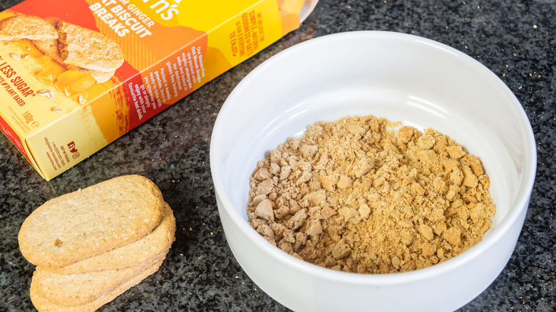 crumbled ginger biscuits in bowl with box