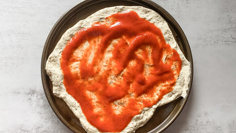 Pizza dough with sauce