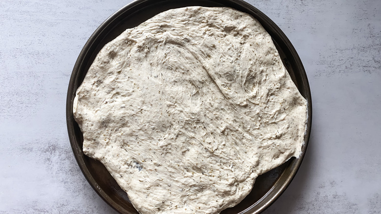 Stretched dough in a pizza pan