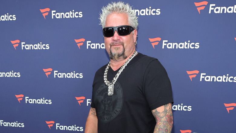 Guy Fieri wearing sunglasses and necklace