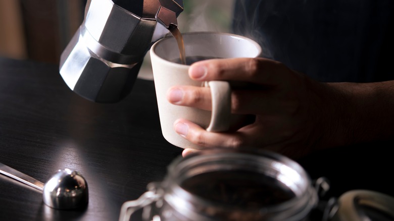 pouring hot coffee into mug