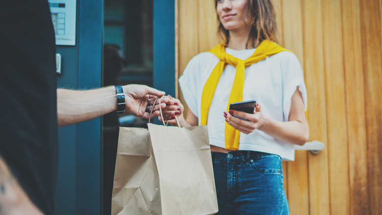 Woman accepting food delivery