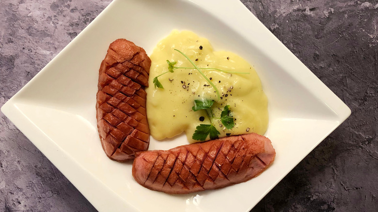 Two halves of knackwurst on a plate