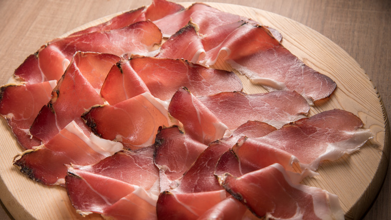 Slices of speck on board